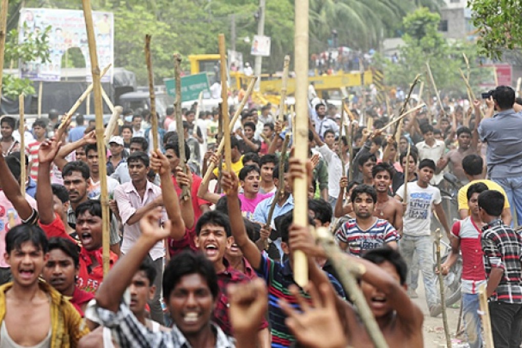 Garment workers shout slogans as they block a street during a protest to demand capital punishment for those responsible for the collapse of the Rana Plaza building in Savar, outside Dhaka on Tuesday Photo: Reuters