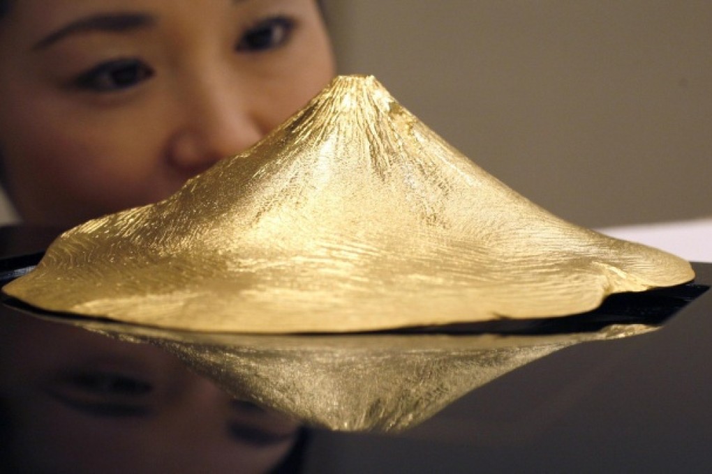 A gold replica of Japan's Mount Fuji by Japanese jewellery maker Ginza Tanaka. Gold prices fell 7.7 per cent last month. Photo: Reuters