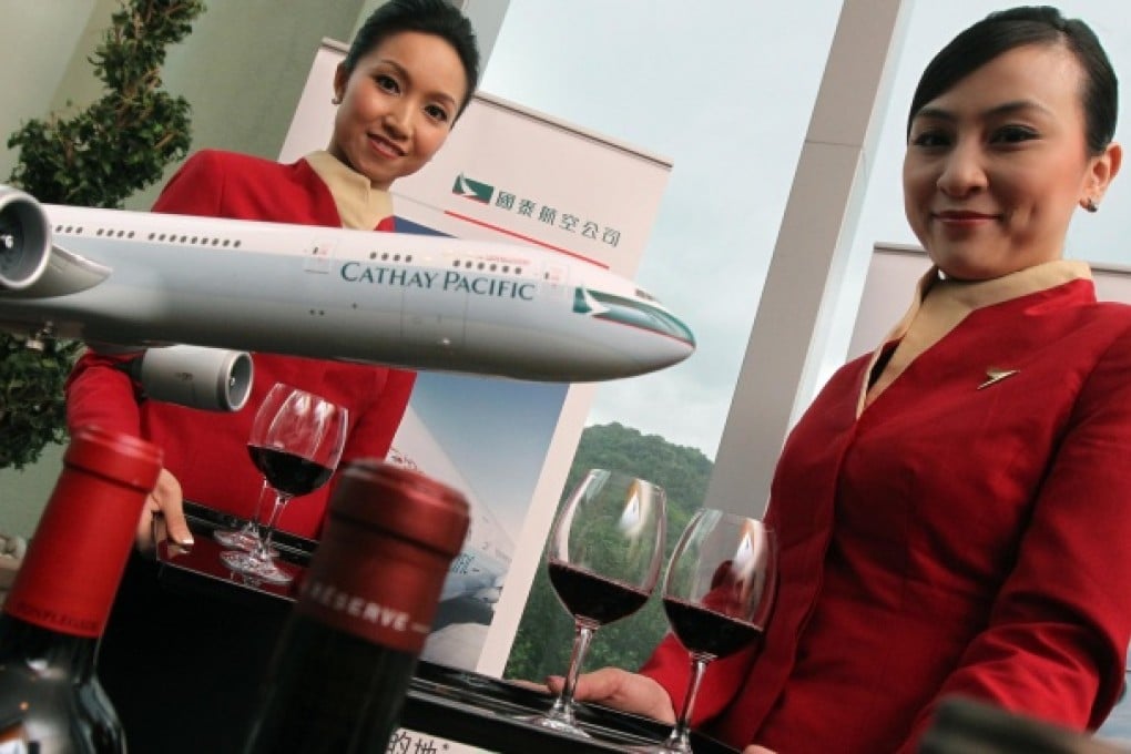 Shaken, not stirred: Cathay Pacific flight attendants with a red wine selected for its ability to withstand plane vibrations. Photo: K. Y. Cheng