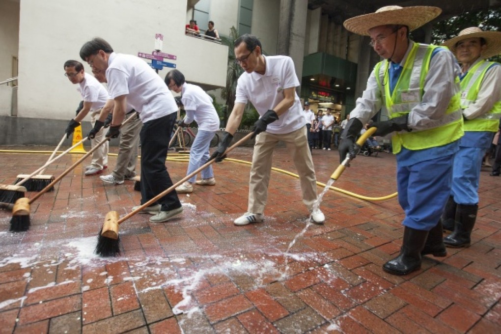 Hong Kong government officials and private cleaning company contractors kick off a three-day cleaning campaign to raise public awareness on the importance of maintaining personal and environmental hygiene. Photo: EPA