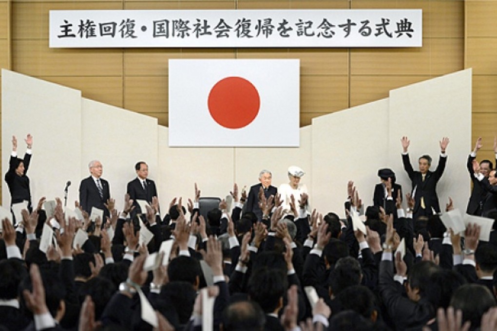Japan's Prime Minister Shinzo Abe (top left) cheers for Emperor Akihito and Empress Michiko during a ceremony in Tokyo on April 28. Photo: AP