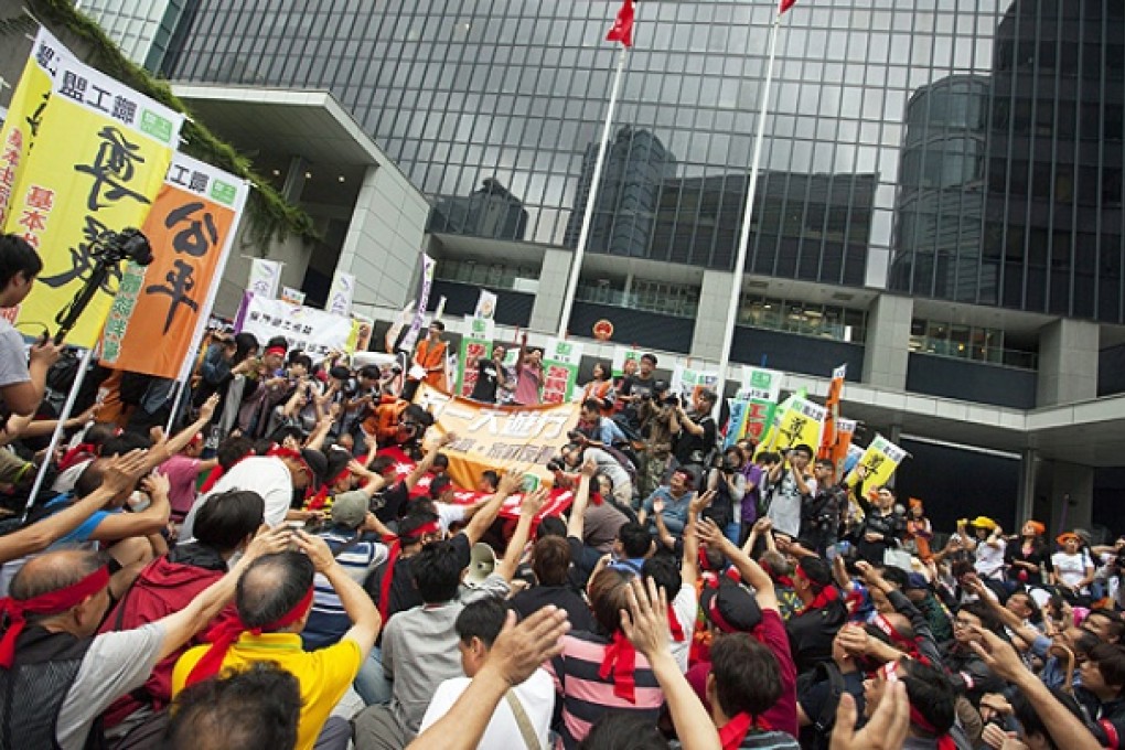 Striking dock workers protest outside government headquarters in Tamar. Photo: EPA