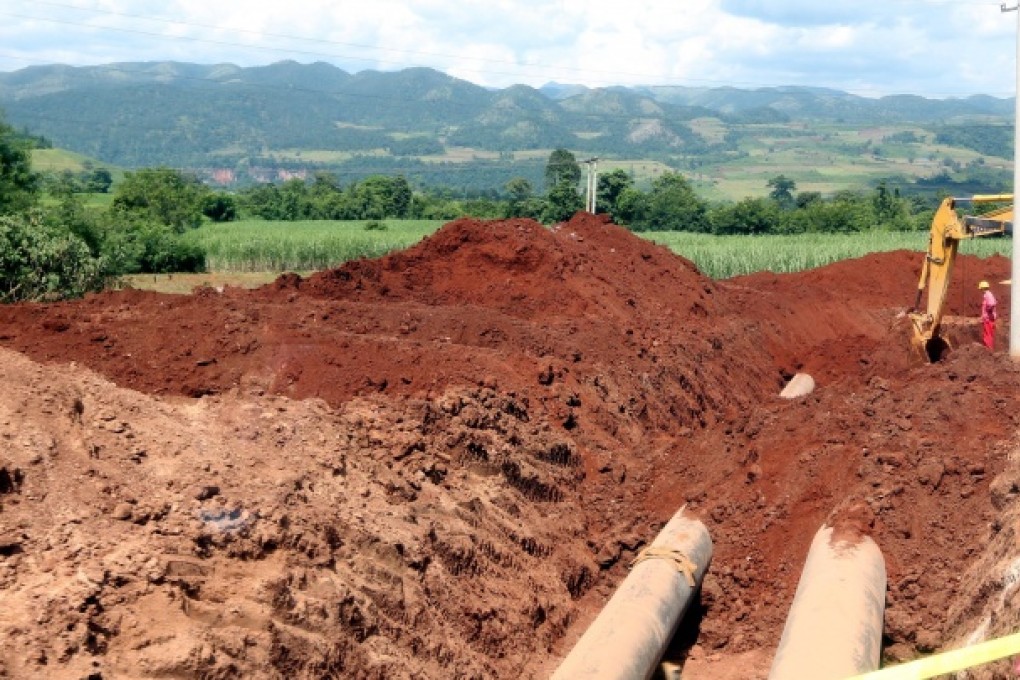 A worker standing at the trench for the Myanmar-China pipeline project near Naung Cho, Northern Shan State, Myanmar. Photo: EPA