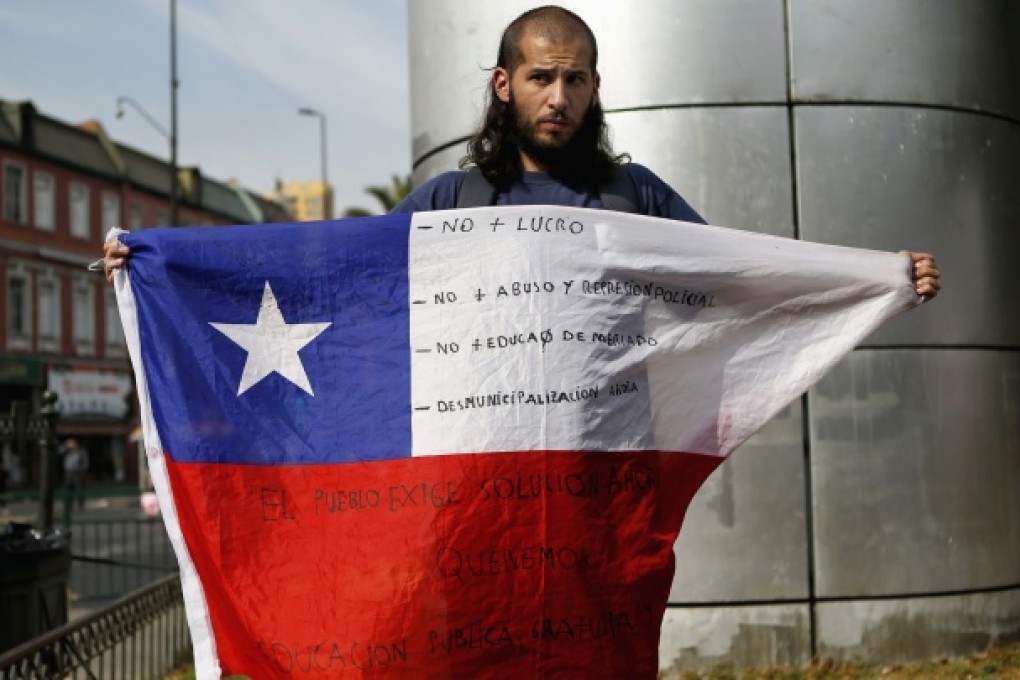 A student protester holds up a Chilean flag in Santiago. Photo: Reuters