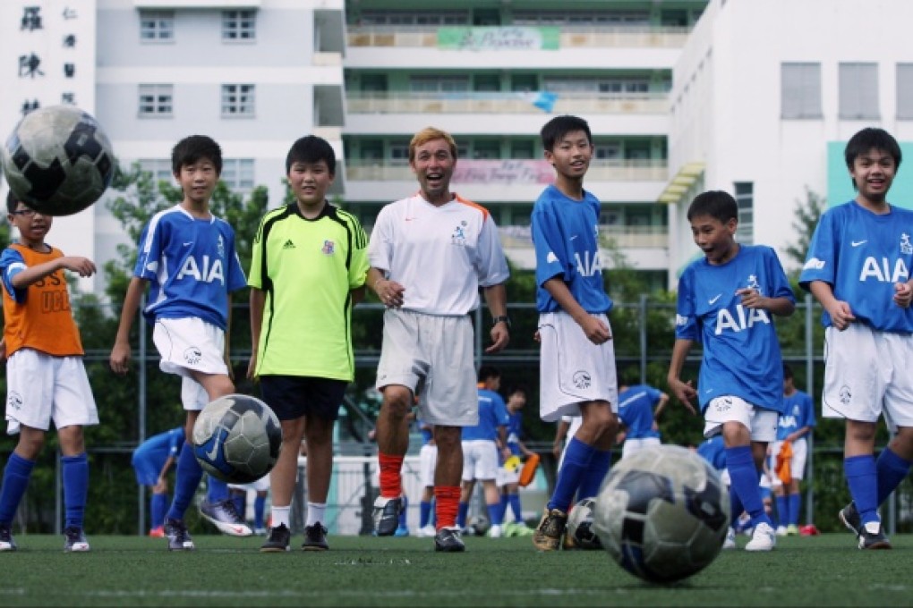 Leslie Santos (centre) of Santos Soccer Training Limited officiates at "Youth Soccer Training Scheme" kick-off ceremony co-organised with The Boys' and Girls' Clubs Association of Hong Kong. Photo: Felix Wong