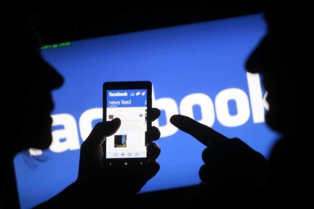 A smartphone user shows the Facebook application on his phone in Zenica, in this photo illustration. Photo: Reuters