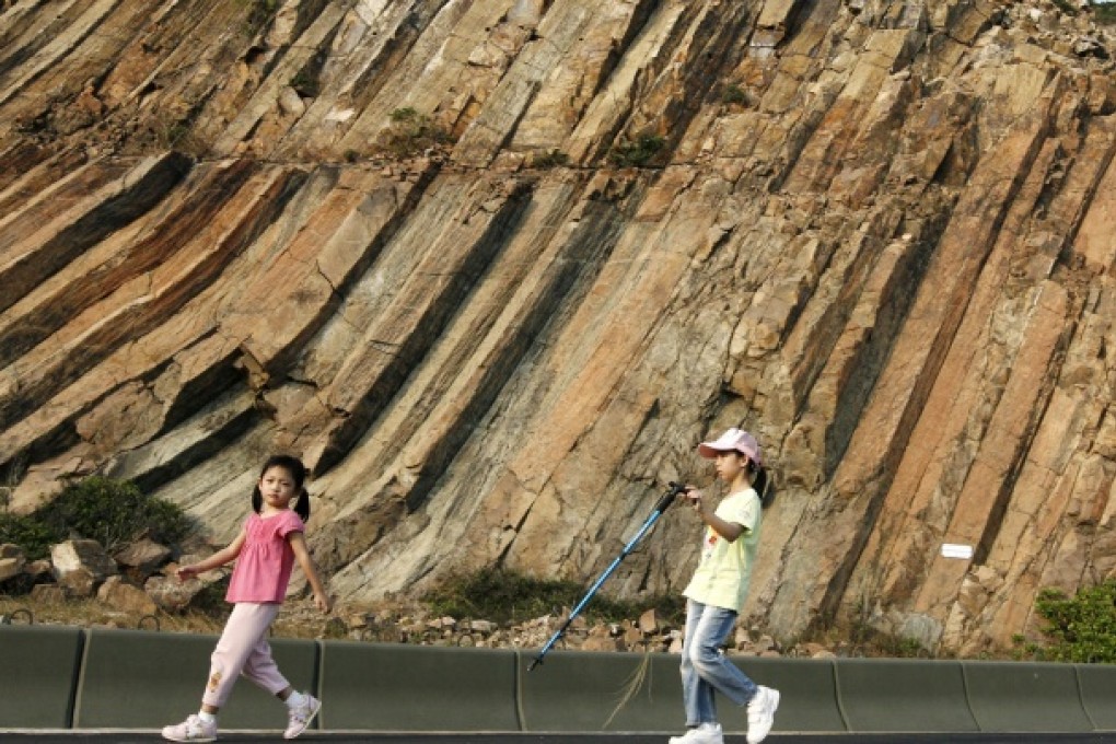 Children walk among hexagonal rocks in Sai Kung. Photo: May Tse