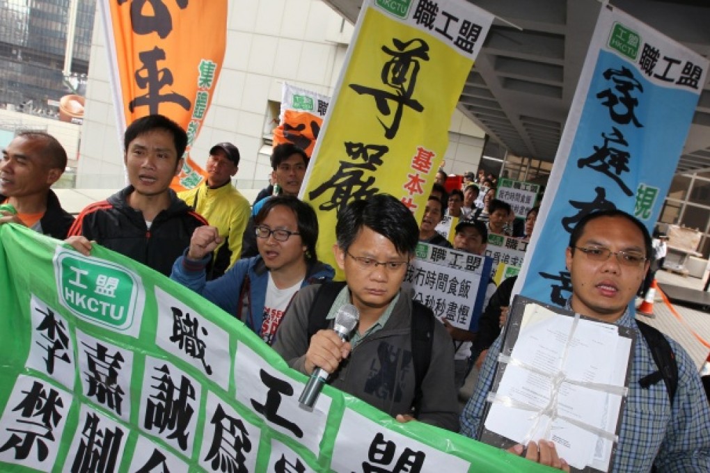 Striking dockers march to court in protest against Cheung Kong's attempt to seek an injunction yesterday. Photo: Felix Wong