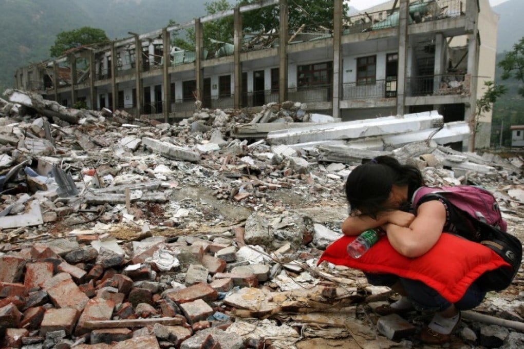 Tang Yulan, 40, weeps amid the ruins of Beichuan Middle School, a month after losing her only daughter in the 2008 Sichuan earthquake. About 4,700 schoolchildren died when more than 7,000 schools collapsed. Photo: Ricky Chung