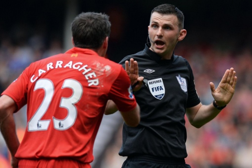 Jamie Carragher argues with the referee. Photo: AFP