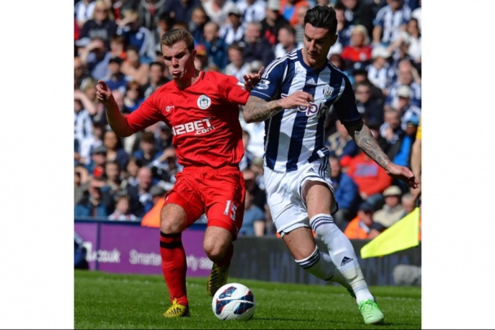 Wigan's Callum McManaman vies with West Brom defender Liam Ridgewell for the ball. Photo: AFP