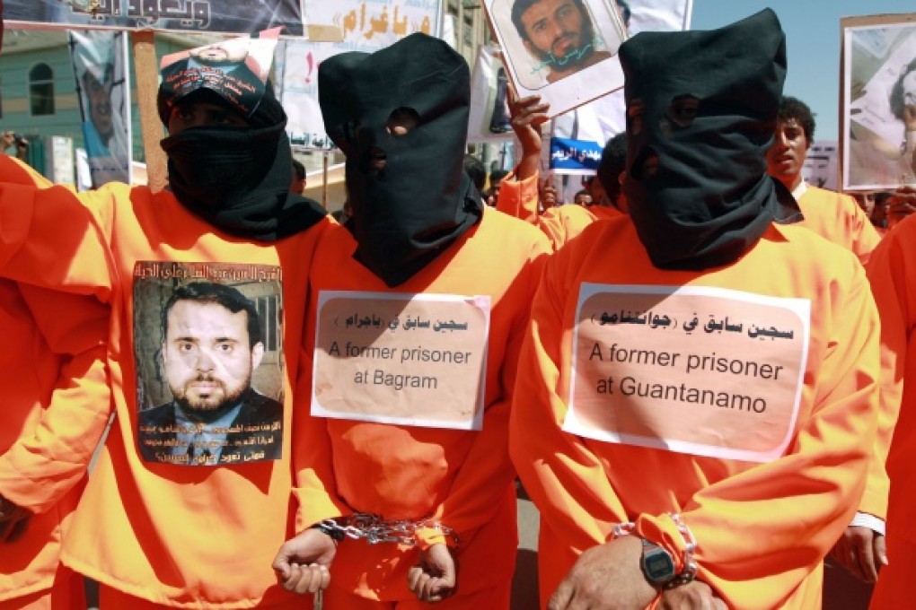 Yemenis wearing orange jumpsuits, similar to those worn by prisoners at the US detention centre in Guantanamo Bay, hold a protest demanding the release of inmates on hunger strike. Photo: AFP