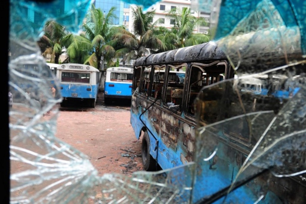 The remnants of a burnt-out government vehicle sits in a parking lot after battles between Islamists and police in the Bangladesh capital of Dhaka yesterday. Photo: AFP