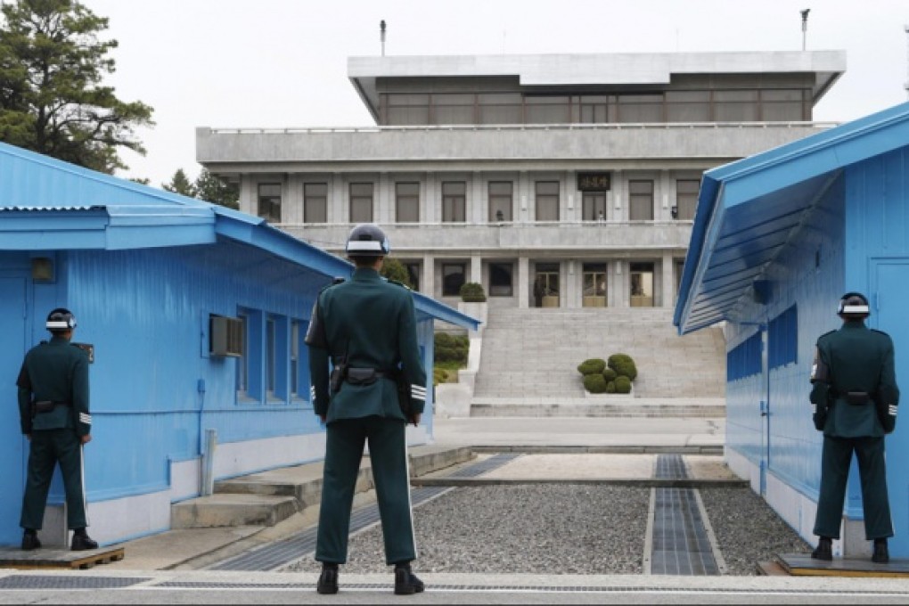 North Korean (centre) and South Korean soldiers at the truce village of Panmunjom in the demilitarized zone dividing the two Koreas, in Paju. Photo: Reuters