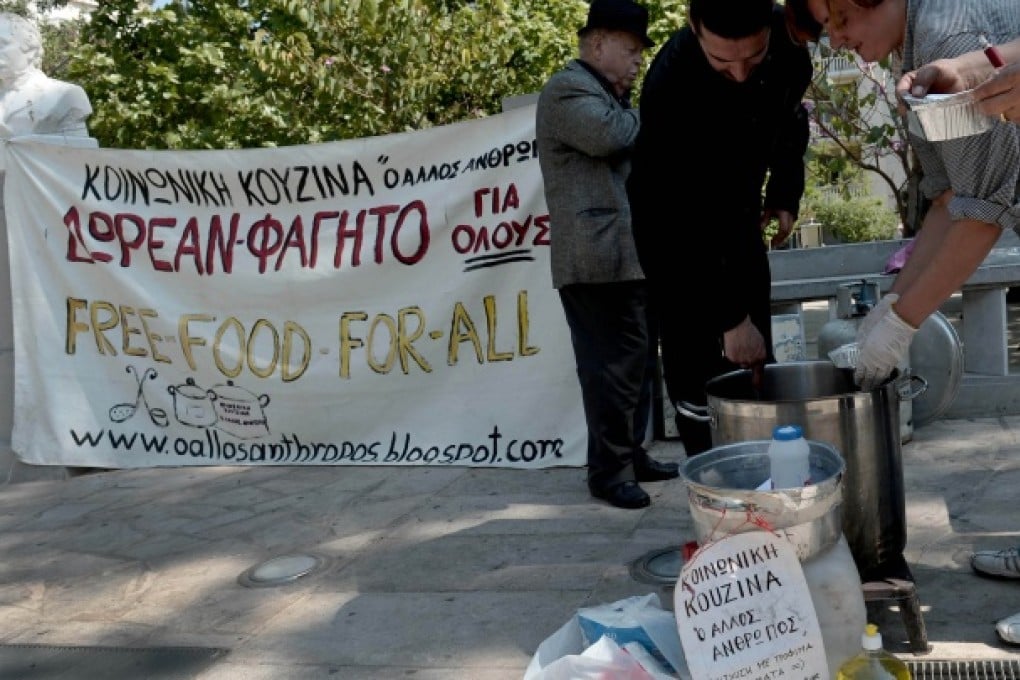A charity doles out food in an Athens square. Social inequality is on the rise in Greece after years of austerity. Photo: AFP