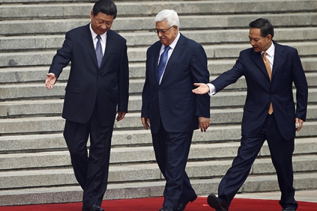 China's President Xi Jinping (left) greets Palestinian counterpart Mahmoud Abbas in Beijing. Photo: Reuters