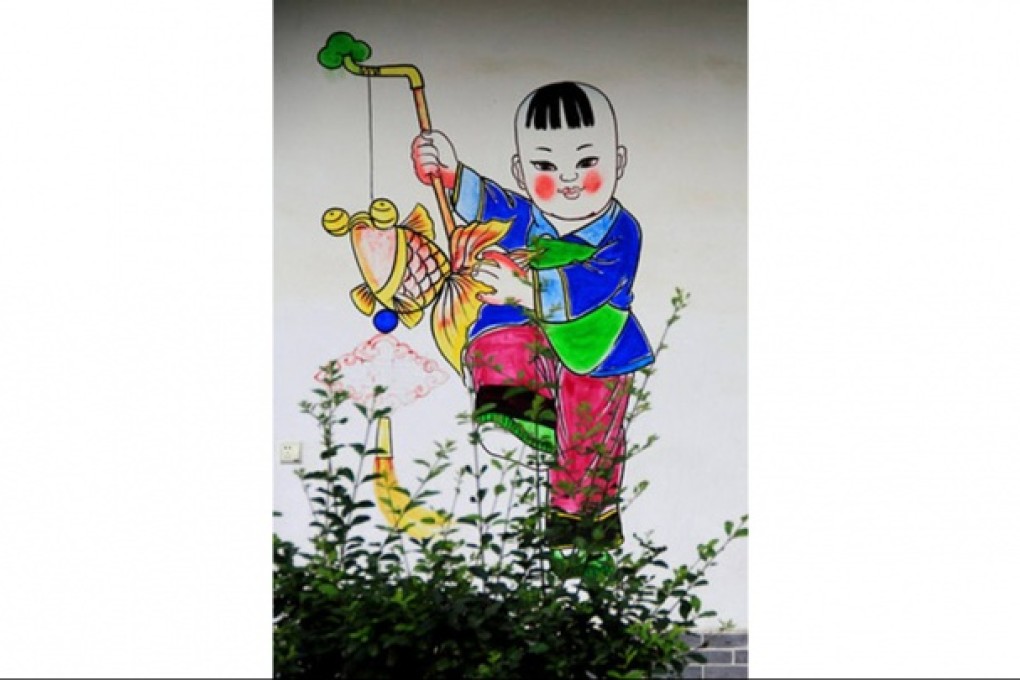 A painting decorates one of the new houses in Jiulong.