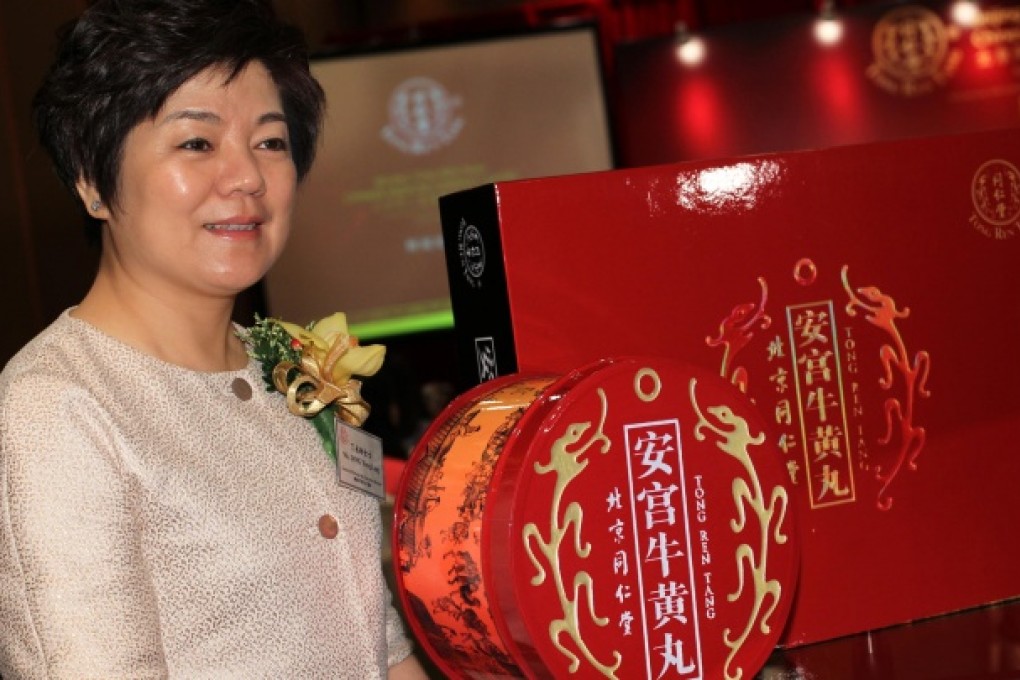 Ding Yong-ling is all smiles yesterday after Tong Ren Tang Chinese Medicine's stunning start as a listed company. Photo: Dickson Lee