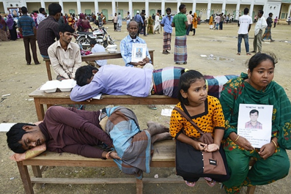 Relatives of missing garment workers wait for news of loved ones. Photo: AP