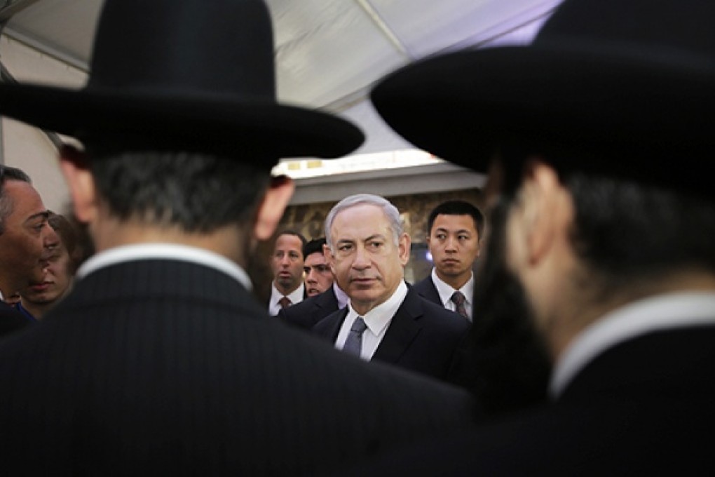 Israeli Prime Minister Benjamin Netanyahu (centre) meets rabbis as he visits the Shanghai Jewish Refugees Museum at former site of Ohel Moshe Synagogue in Shanghai, on Tuesday. Photo: AP