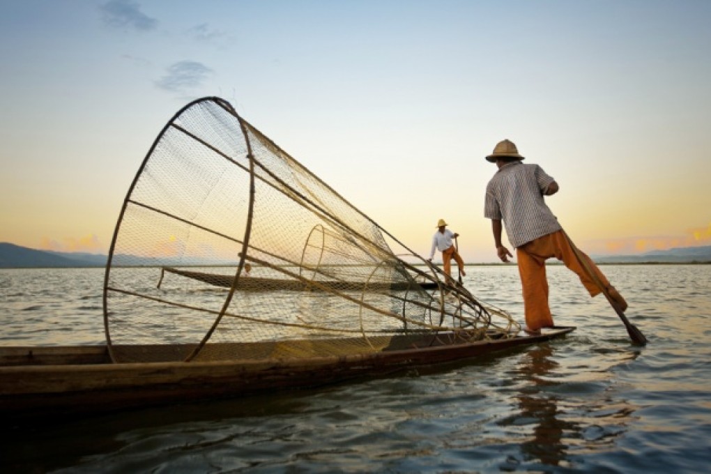 Fishermen on Lake Inle paddle with their legs. Photo: Felix Hug, John Lander, Graeme Green, Katie Garrod