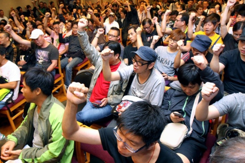 Over 300 striking dock workers attended a general meeting in Wan Chai. Photo: David Wong