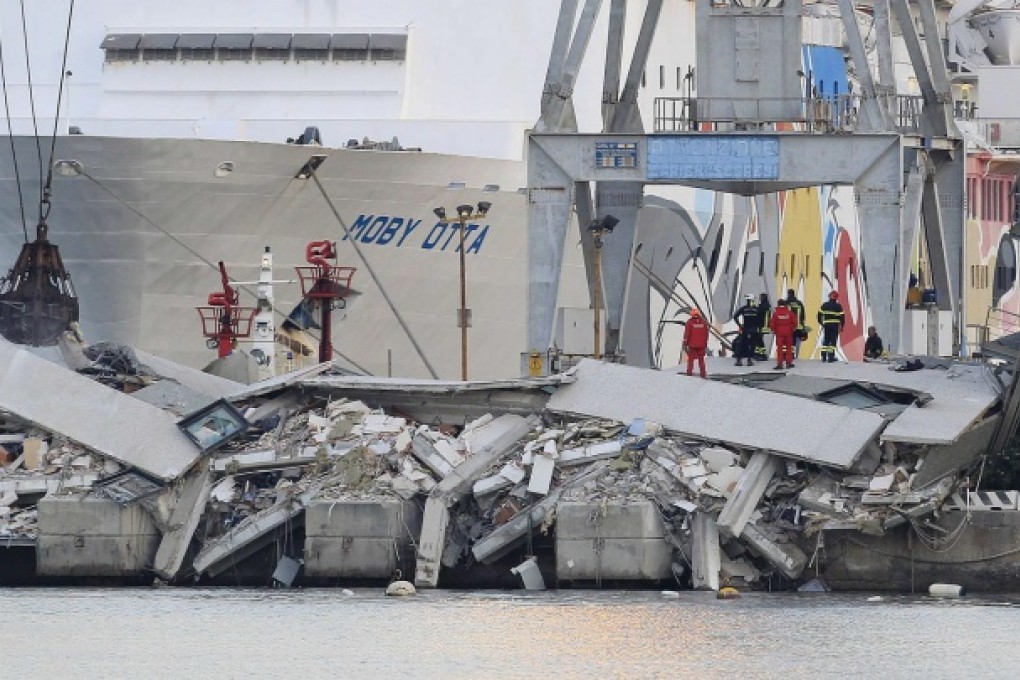 Part of the control tower at Genoa lies in a heap of rubble yesterday.Photo: Reuters