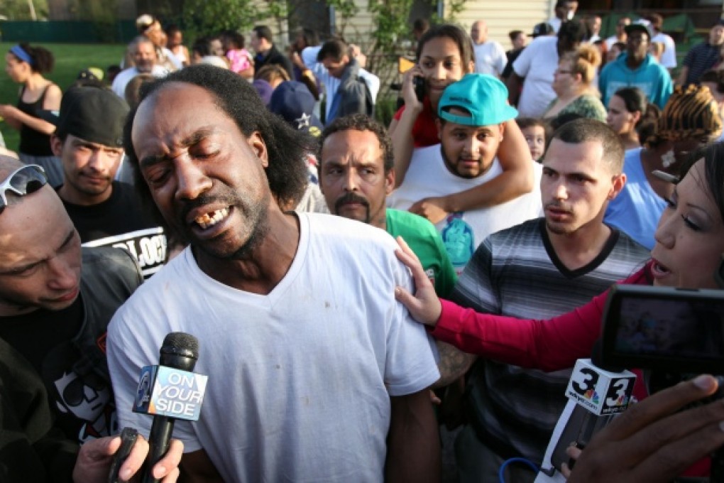 Charles Ramsey speaks to media outside his home.