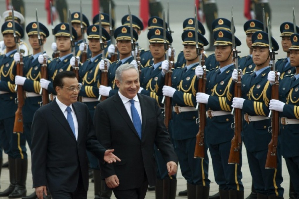 Premier Li Keqiang and Israeli Prime Minister Benjamin Netanyahu review a guard of honour in Beijing yesterday. Photo: AP