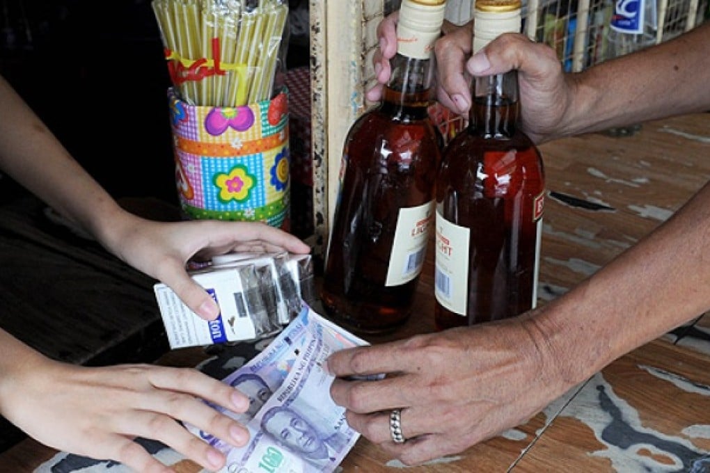 The Philippines has banned people from carrying large amounts of cash and buying alcohol in controversial efforts to curb rampant vote buying and violence ahead of elections next week. Photo: AFP
