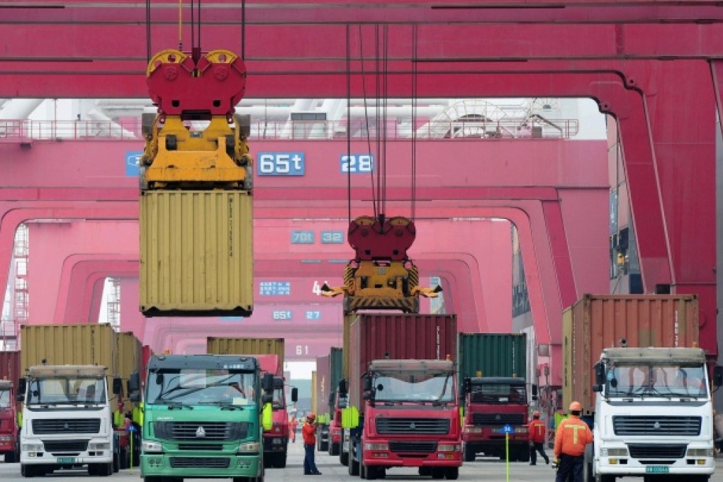 Shipping containers are transported in a port in Qingdao. Photo: AFP