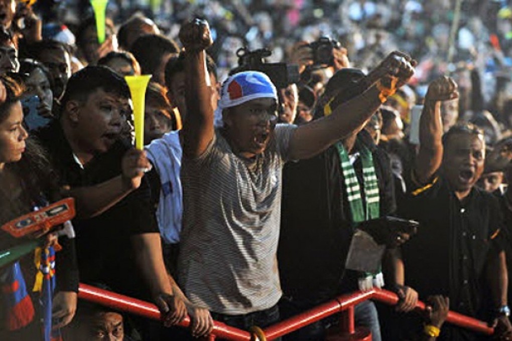 A supporter shouts slogans as Malaysian opposition leader Anwar Ibrahim speaks during a rally at a stadium in Kelana Jaya, Selangor on Wednesday. Malaysia’s Anwar calls for nationwide protest tour. Photo: AFP