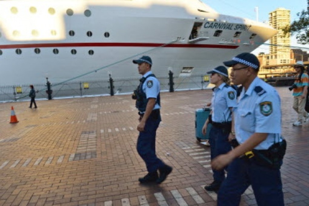 Police arrive at Sydney's Circular Quay after two passengers fell overboard from the cuise ship Carnival Spirit as it returned to Sydney from a Pacific cruise. Photo: AFP