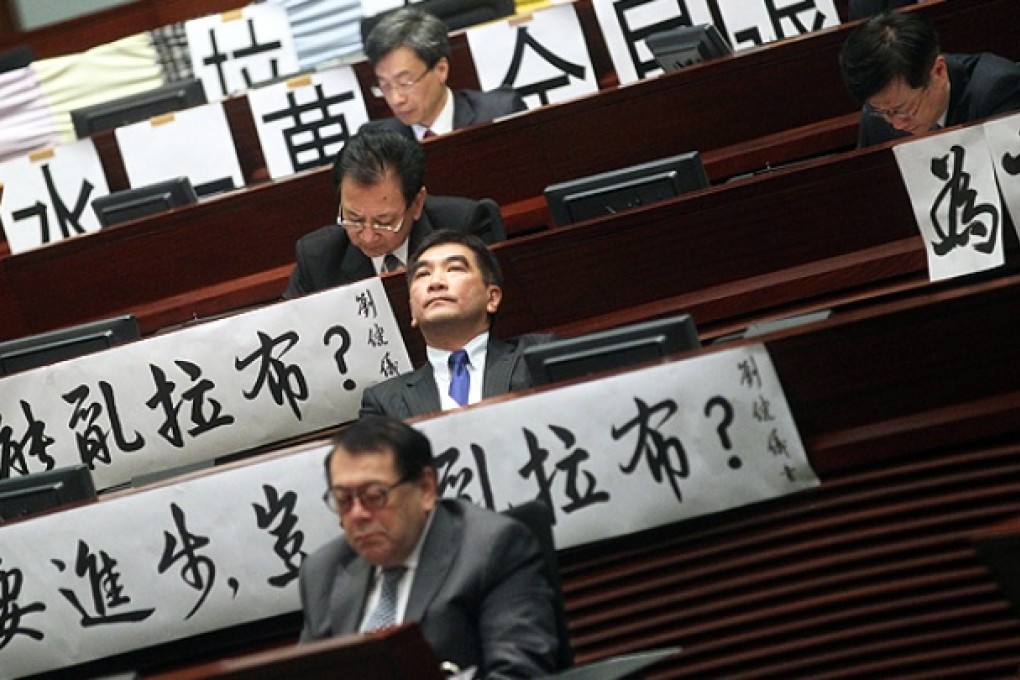 Pro-establishment lawmakers display banners denouncing the filibuster in Legco. Photo: K. Y. Cheng