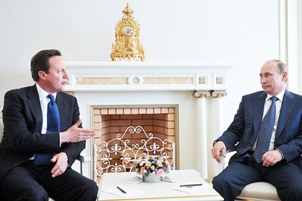 Britain's Prime Minister David Cameron (left) speaks to Russian President Vladimir Putin during their meeting in the Bocharov Ruchei residence in the Black Sea resort of Sochi, Russia, on Friday. Photo: AP