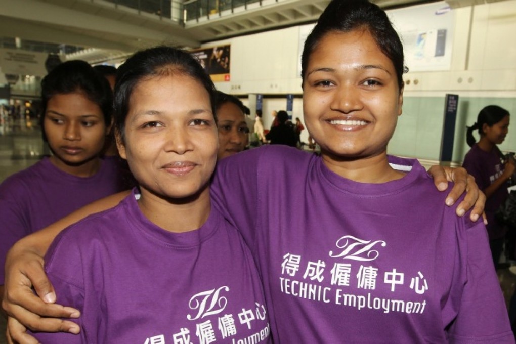 Domestic helpers Sefali Akter (left) and her daughter Mowsami pose for a picture after arriving in Hong Kong. Photo: Edward Wong