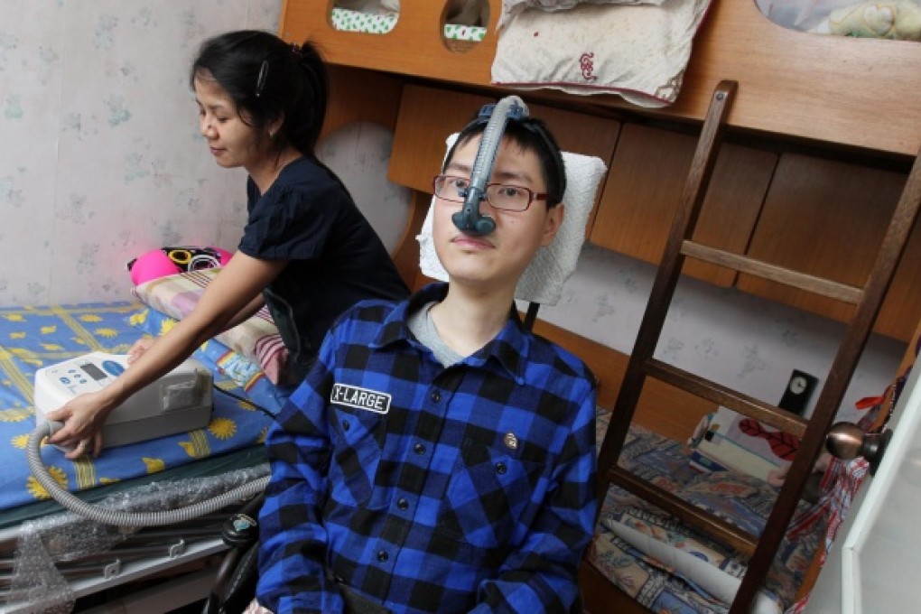 Samuel Lo and his family's domestic helper Nanik. Photo: May Tse