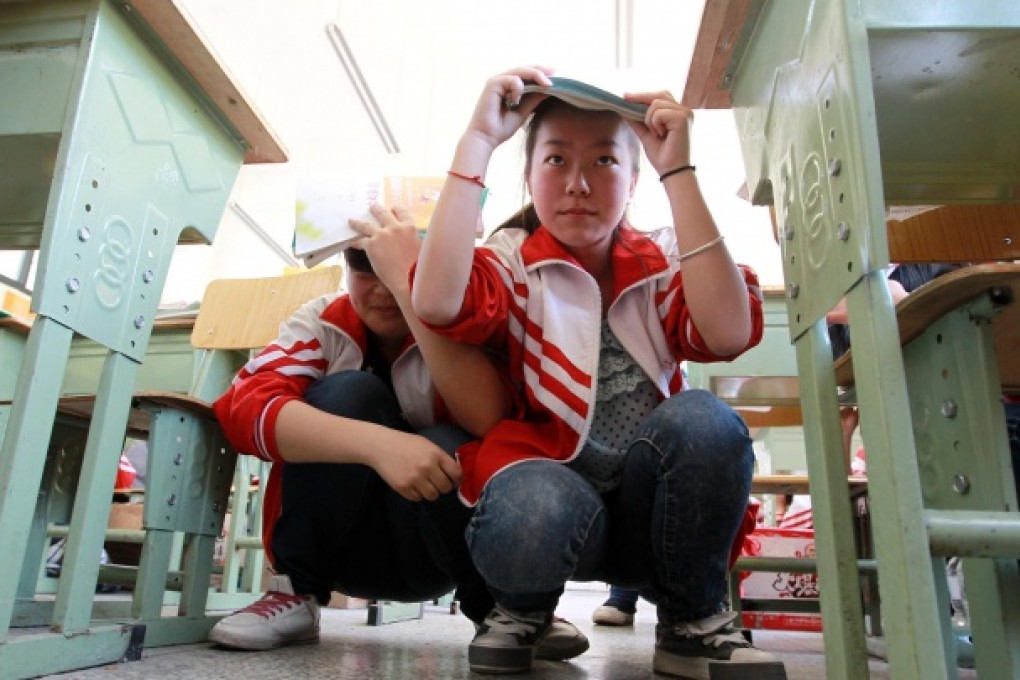 Students at Qiyi Yingxiu Middle School take part in an earthquake emergency drill. Photo: Simon Song