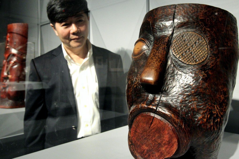 Co-curator Kuiyi Shen beside one of the works. Photo: K. Y. Cheng