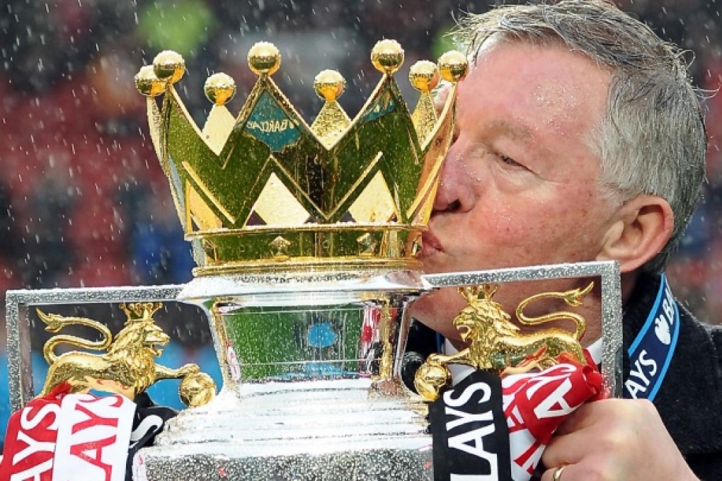 Manchester United's retiring manager Alex Ferguson kisses the Premier League trophy after his side's victory over Swansea City. Photo: AFP