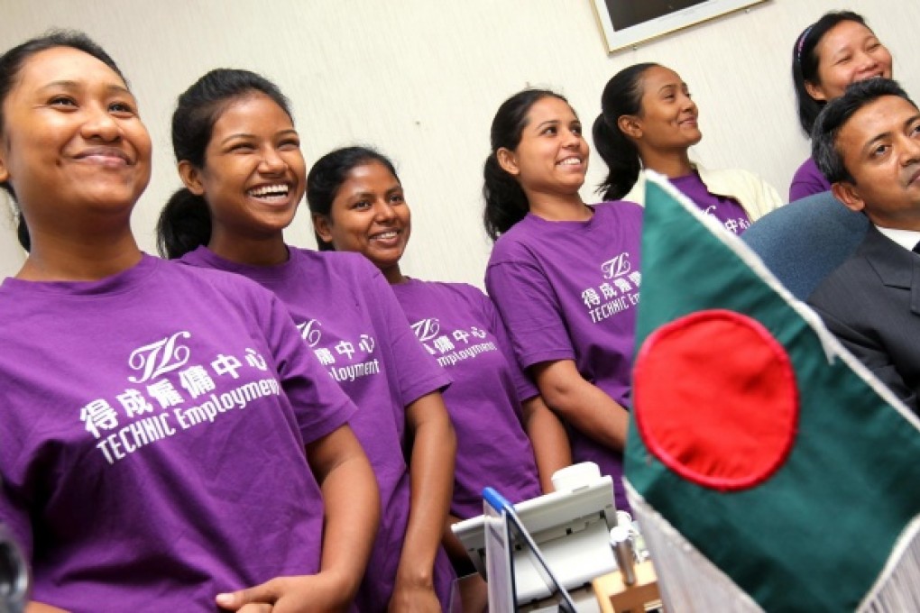 Fresh faces in Hong Kong (from left) Aongmapolle Marma, Paiching Marma, Murnn Har, Sarmen Akter Rima, Rokeya Akter and Hlanu Marma, with consul general Mohammad Sarwar Mahmood. The domestic helpers have big plans for their time working here. Photo: K. Y. Cheng
