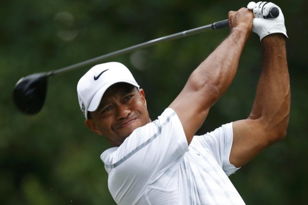 Tiger Woods hits from the 11th tee during The Players Championship at TPC Sawgrass. Woods went on to win the tournament. Photo: Reuters