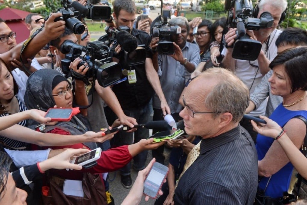 Rick Todd (second, right) and his wife Mary, talk to reporters after the first of the inquiry into the death of their son, Shane. Photo: AFP