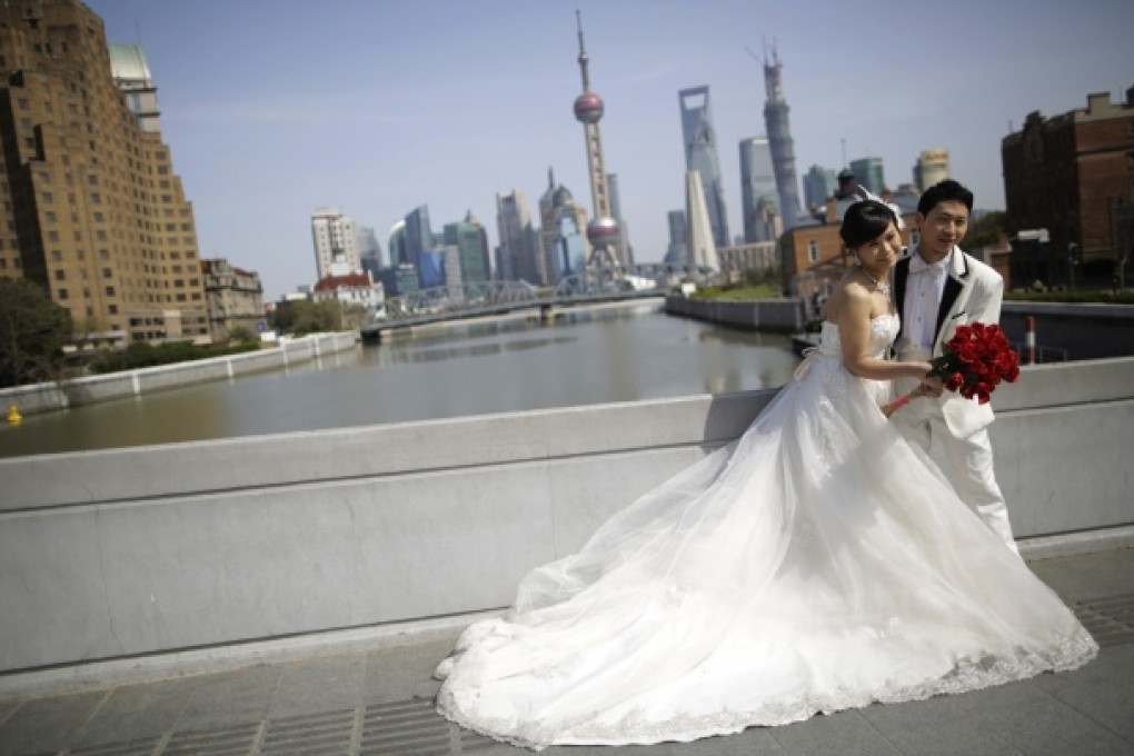 A newlywed couple poses for wedding photo shooting in Shanghai. Photo: AP