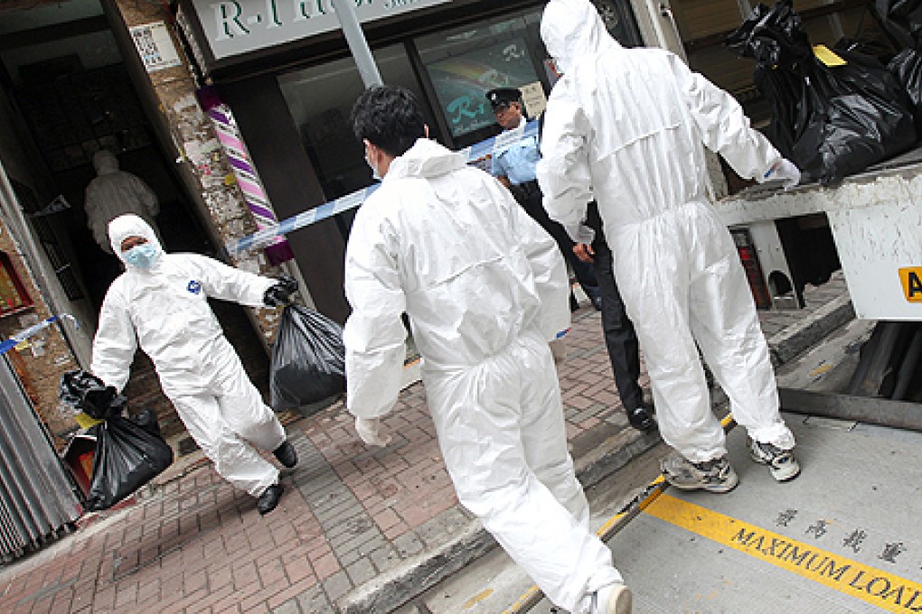 Police collect evidence after bodies were found in a Tai Kok Tsui flat in March. Photo: David Wong