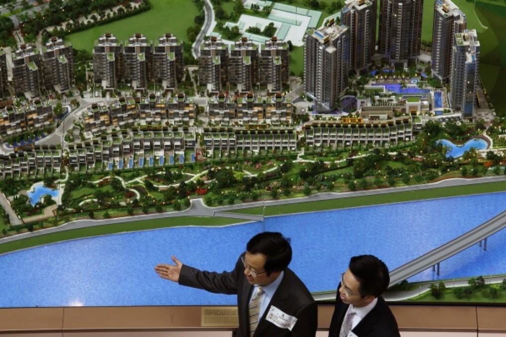 Representatives from a developer introduce a residential property development in Hong Kong. Photo: Reuters