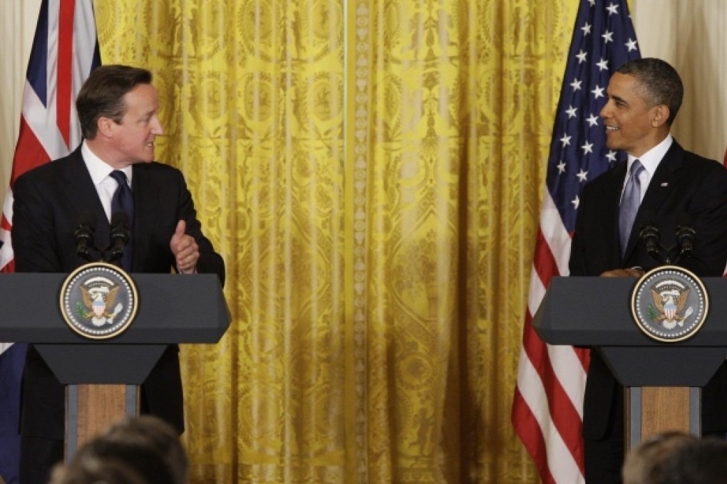 British Prime Minister David Cameron addresses US President Barack Obama in a White House press conference. Photo: Reuters