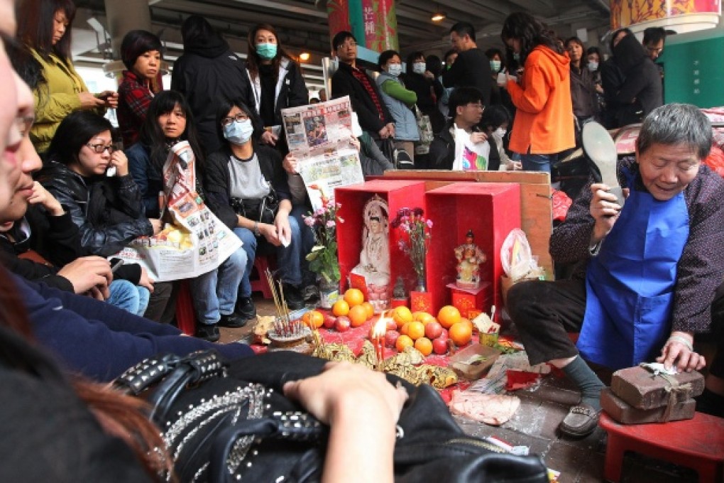 Tourists can get the "devil-beaters" in Causeway Bay to remove people they do not like from their lives. Photo: Martin Chan