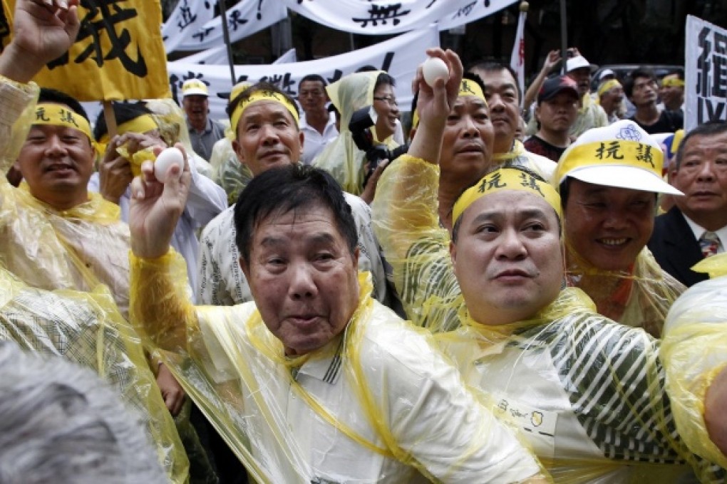 Activists hurl eggs at the Manila Economic and Cultural Office, the de facto Philippine embassy in Taiwan, at a protest on Monday over the fisherman's death. Photo: Reuters