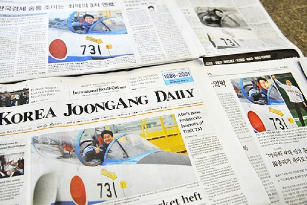 South Korean newspaper front pages show Japanese Prime Minister Shinzo Abe seated inside a military jet trainer on Sunday. Photo: AFP